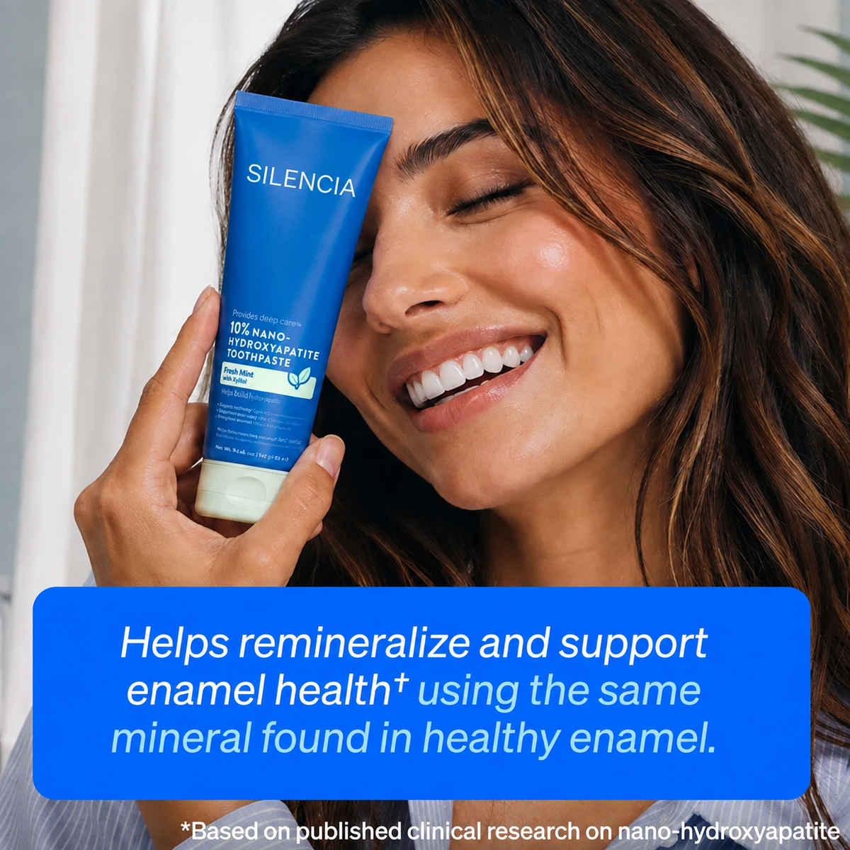 Woman holding Silencia nano-hydroxyapatite toothpaste